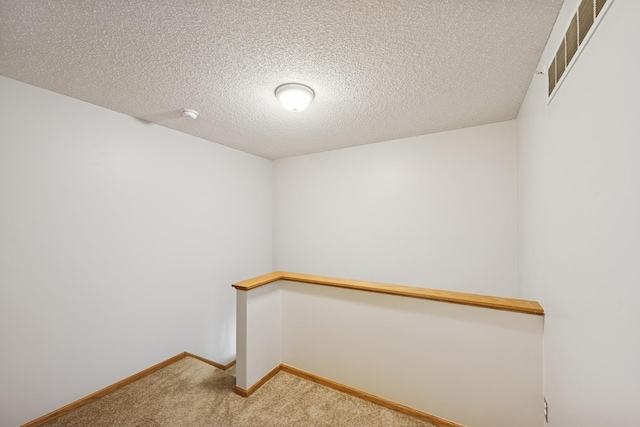 interior space featuring visible vents and light carpet
