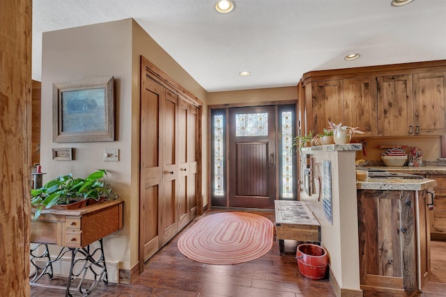 foyer entrance with hardwood / wood-style floors and recessed lighting
