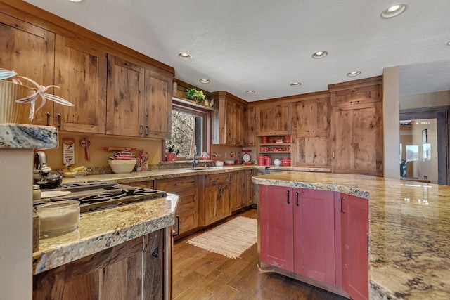 kitchen with a sink, wood finished floors, stainless steel gas stovetop, and recessed lighting