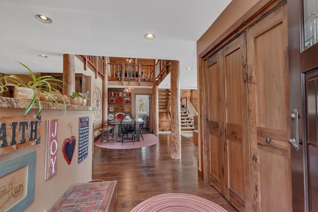 foyer entrance with recessed lighting, dark wood finished floors, and stairs