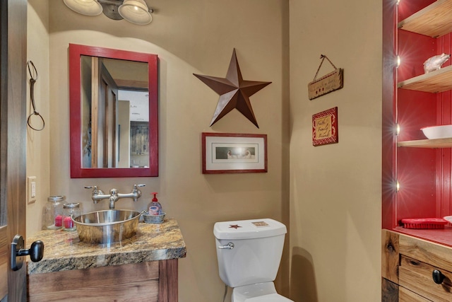 bathroom with toilet and vanity