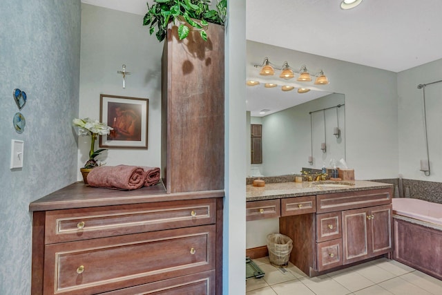 bathroom featuring a bathtub, vanity, and tile patterned flooring