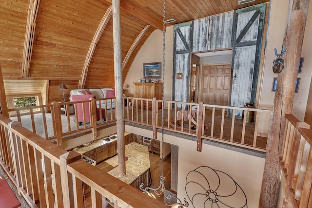 additional living space with wooden ceiling, vaulted ceiling with beams, and wood finished floors