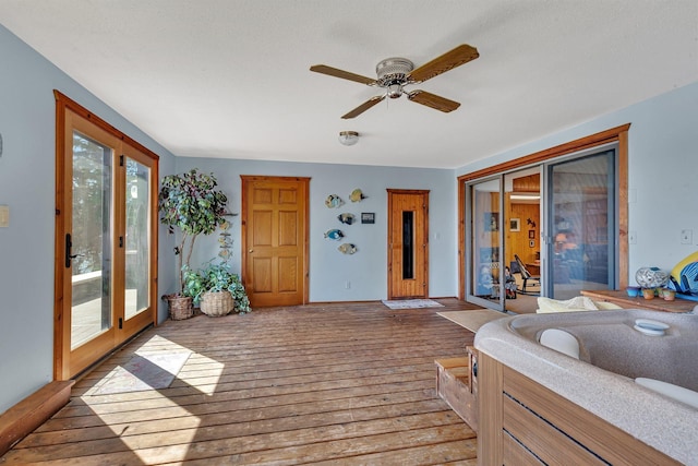 interior space with ceiling fan