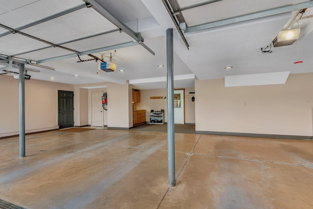 garage with recessed lighting, a garage door opener, and baseboards