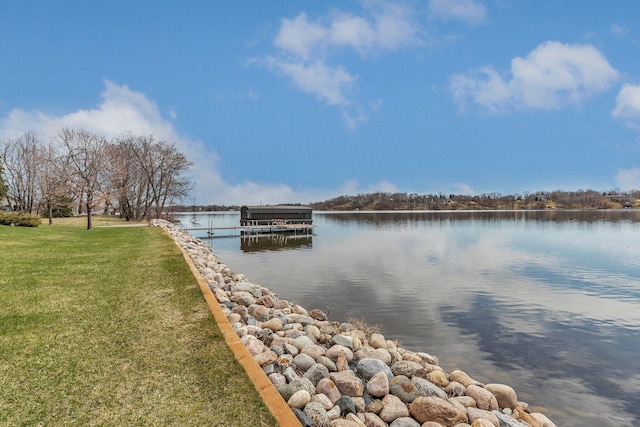 view of dock featuring a yard and a water view