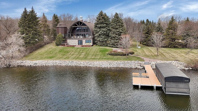 view of dock featuring a yard and a water view