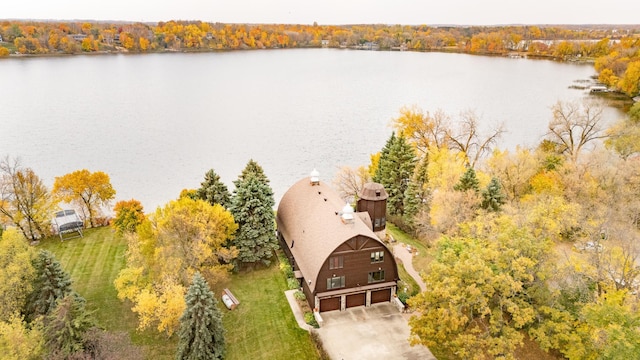 birds eye view of property with a water view and a view of trees