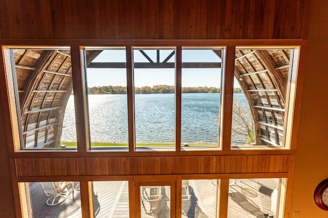 room details featuring wooden walls and a water view