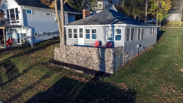 884 White Clover Beach Rd, Detroit Lakes, MN 56501 - view of home's exterior featuring a lawn, a chimney, and a shingled roof