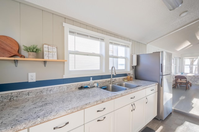 884 White Clover Beach Rd, Detroit Lakes, MN 56501 - kitchen with plenty of natural light, a sink, white cabinets, and freestanding refrigerator