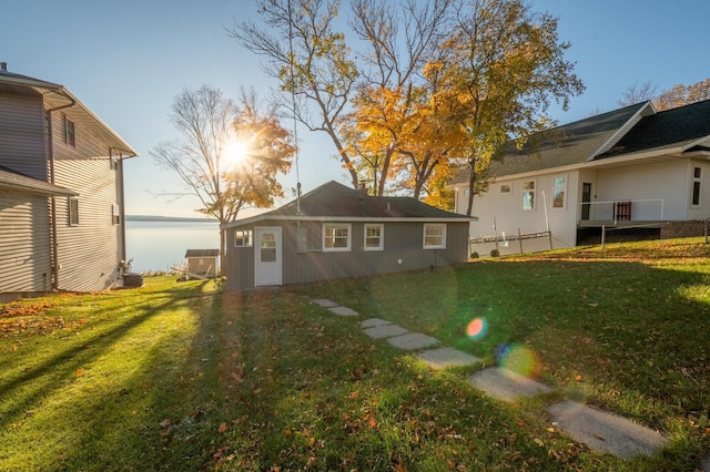 884 White Clover Beach Rd, Detroit Lakes, MN 56501 - rear view of house featuring a lawn and a water view