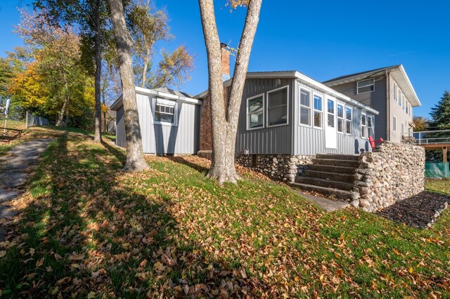 884 White Clover Beach Rd, Detroit Lakes, MN 56501 - exterior space with a sunroom, a yard, and an outbuilding