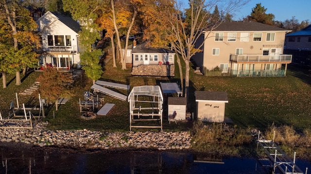 884 White Clover Beach Rd, Detroit Lakes, MN 56501 - back of property with a water view, a yard, a balcony, and central AC unit