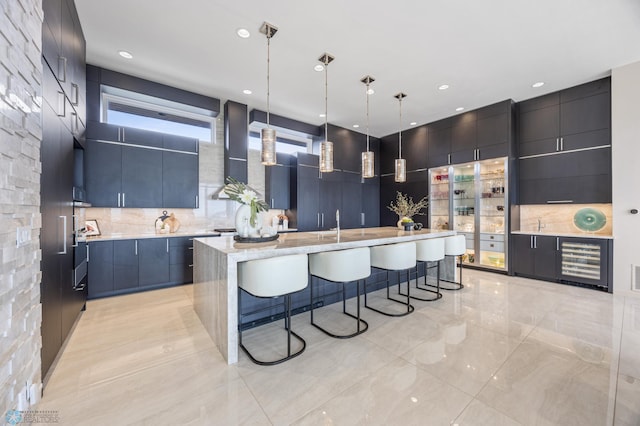 505 Tessa Dr, Moorhead, MN 56560 - kitchen with a breakfast bar, ventilation hood, modern cabinets, and beverage cooler