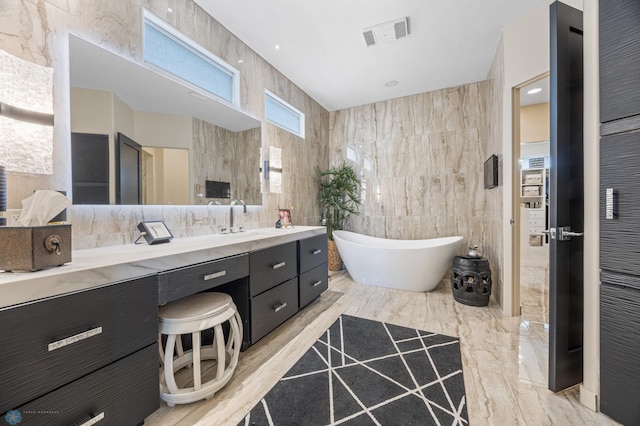 505 Tessa Dr, Moorhead, MN 56560 - bathroom with a soaking tub, tile walls, and vanity