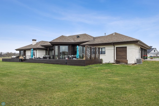 505 Tessa Dr, Moorhead, MN 56560 - back of house with central AC, a chimney, a shingled roof, and a lawn