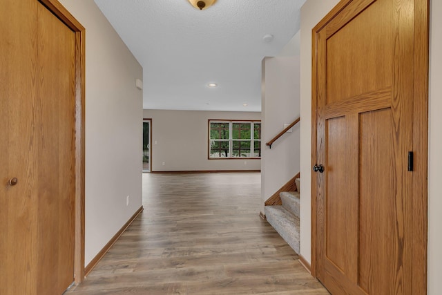 103 Grandview Ct, Buffalo, MN 55313 - hallway featuring wood finished floors, stairs, baseboards, recessed lighting, and a textured ceiling