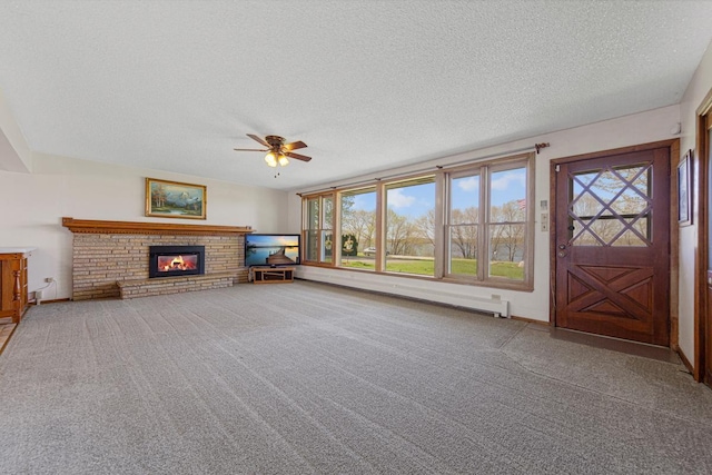 unfurnished living room with ceiling fan, a textured ceiling, baseboard heating, and a healthy amount of sunlight
