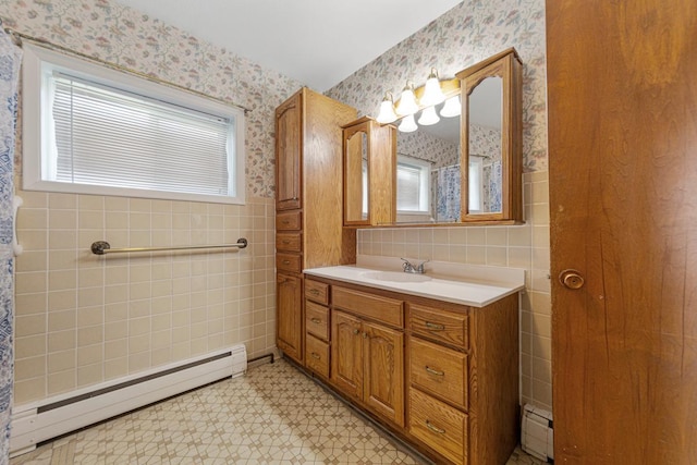 bathroom with wallpapered walls, tile walls, and a baseboard heating unit