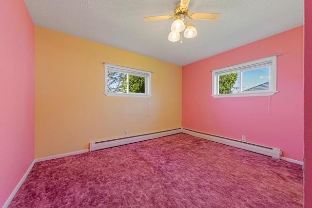 empty room with carpet flooring, baseboard heating, and a healthy amount of sunlight