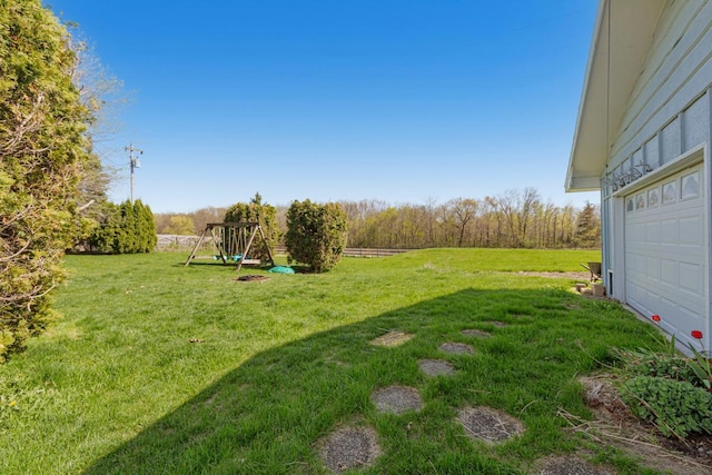view of grassy yard with a playground