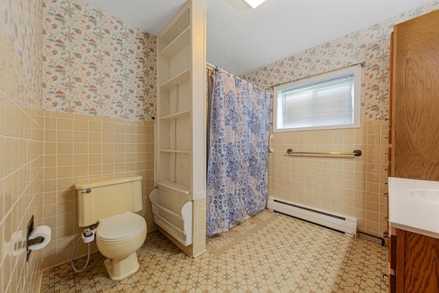 full bathroom featuring a baseboard radiator, wallpapered walls, tile walls, wainscoting, and toilet