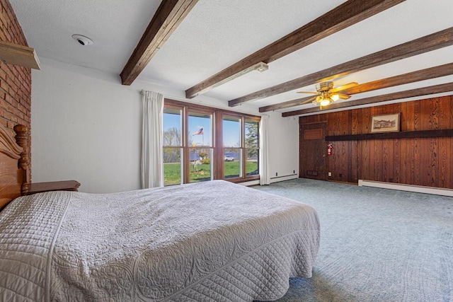 carpeted bedroom featuring beam ceiling, wooden walls, a textured ceiling, baseboards, and a baseboard heating unit