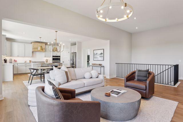 4029 Arbor Dr, Woodbury, MN 55129 - living room featuring a chandelier, light wood-style floors, baseboards, and recessed lighting