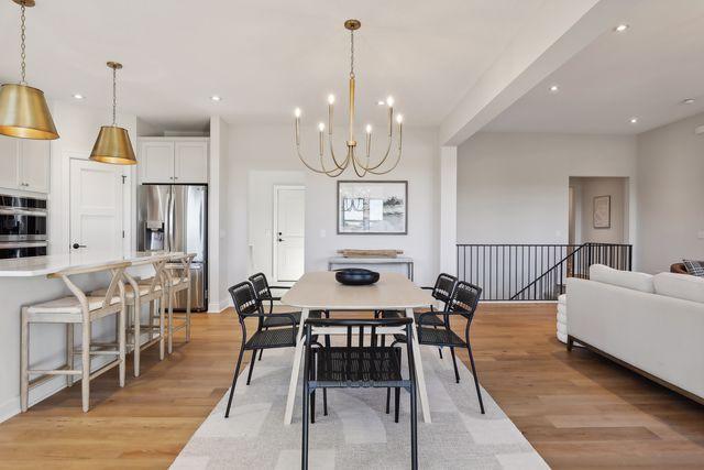 4029 Arbor Dr, Woodbury, MN 55129 - dining space featuring light wood-style floors, a chandelier, and recessed lighting