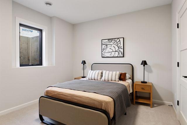 4029 Arbor Dr, Woodbury, MN 55129 - bedroom with light carpet and baseboards