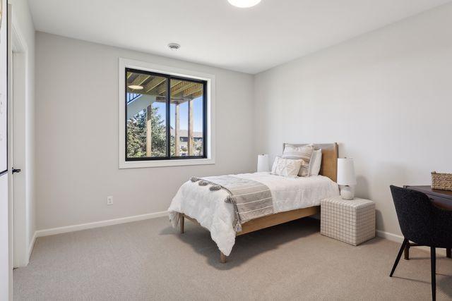 4029 Arbor Dr, Woodbury, MN 55129 - bedroom featuring baseboards and light colored carpet