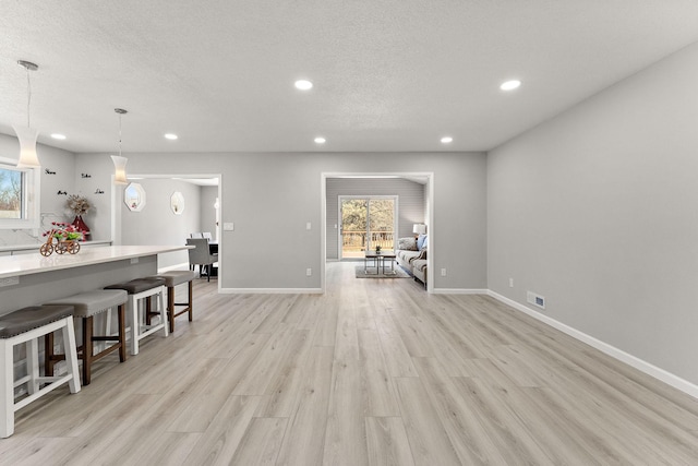 13804 Euclid Ct, Apple Valley, MN 55124 - living area with recessed lighting, light wood-type flooring, and a textured ceiling