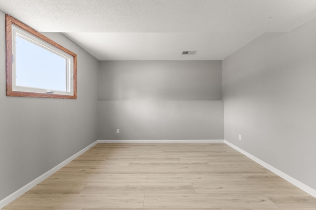 13804 Euclid Ct, Apple Valley, MN 55124 - unfurnished room featuring light wood-style floors, baseboards, and a textured ceiling