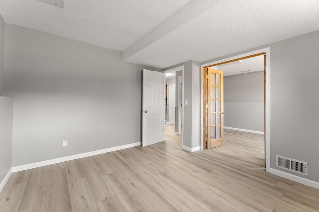 13804 Euclid Ct, Apple Valley, MN 55124 - unfurnished bedroom with light wood-style flooring, baseboards, and a textured ceiling
