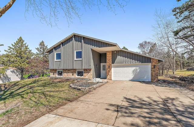 13804 Euclid Ct, Apple Valley, MN 55124 - split level home with board and batten siding, brick siding, a garage, driveway, and a front lawn