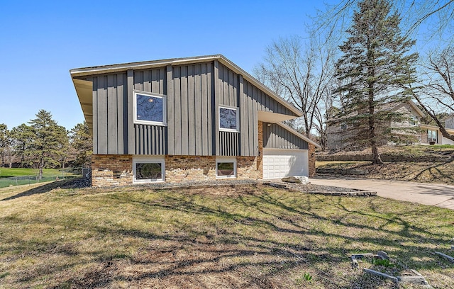 13804 Euclid Ct, Apple Valley, MN 55124 - view of side of property featuring board and batten siding, driveway, a garage, and a lawn