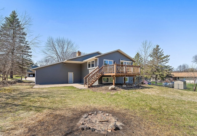 13804 Euclid Ct, Apple Valley, MN 55124 - back of house featuring stairway, a deck, a chimney, and a yard