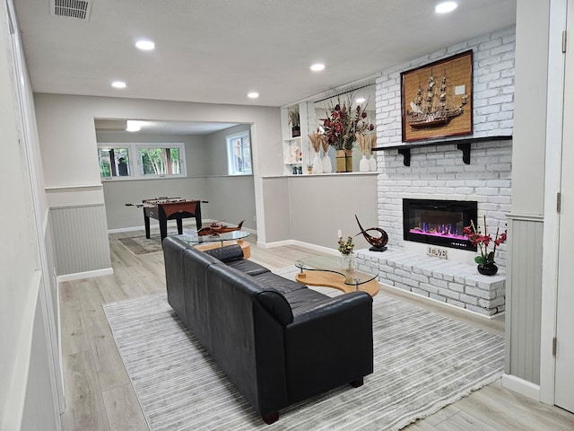 13804 Euclid Ct, Apple Valley, MN 55124 - living room with wood finished floors, a fireplace, wainscoting, recessed lighting, and baseboards