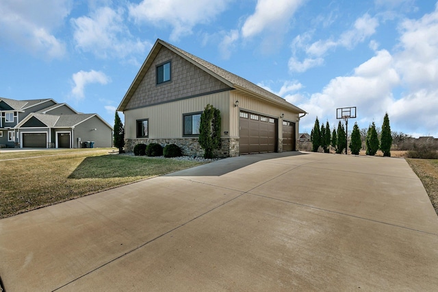 exterior space featuring an attached garage, stone siding, board and batten siding, a yard, and driveway