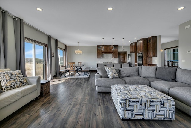 living area with recessed lighting and dark wood-style floors