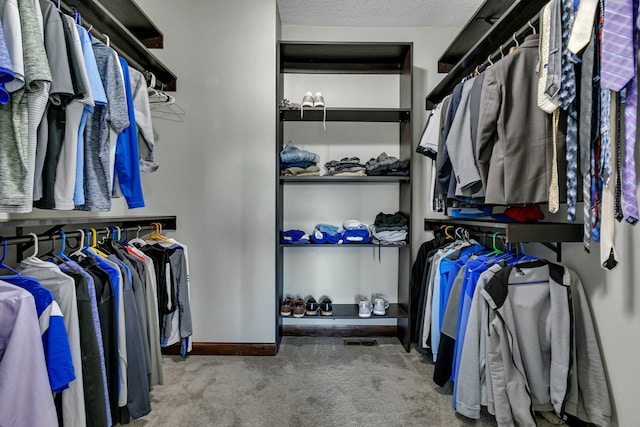 spacious closet with carpet floors