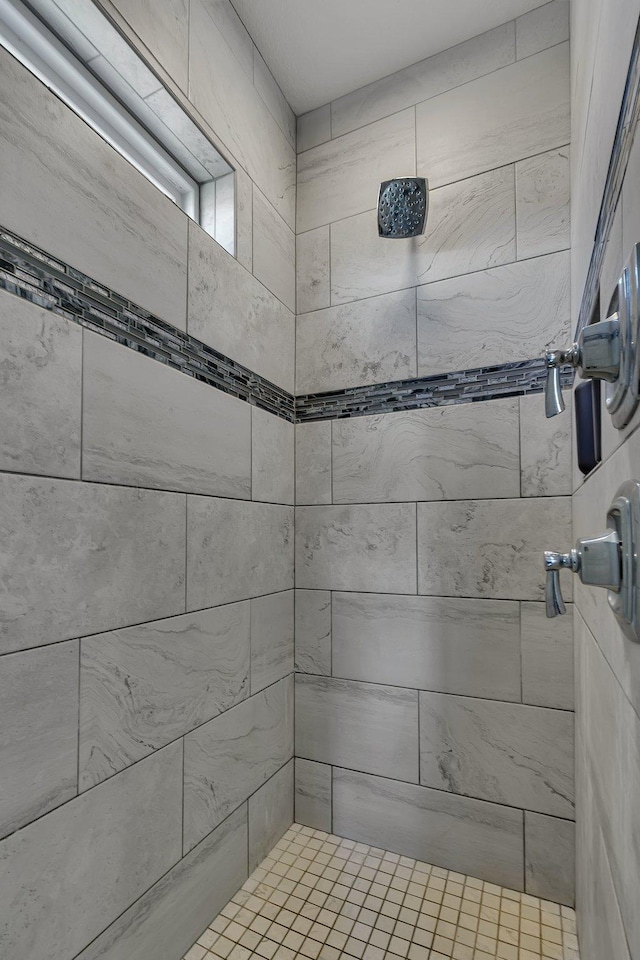 bathroom with tiled shower