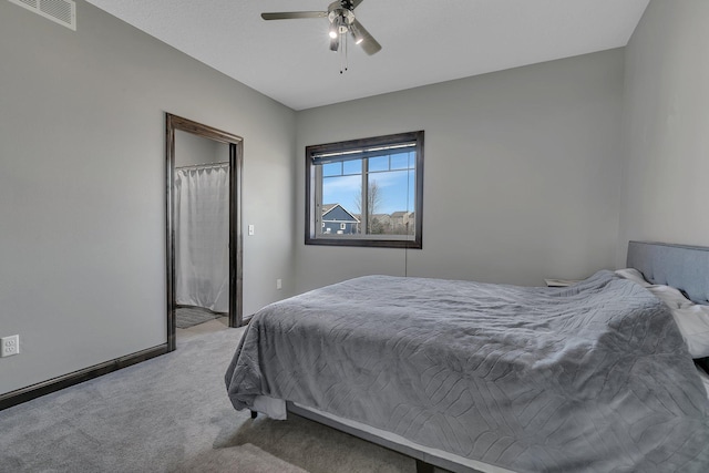 bedroom featuring light carpet, a ceiling fan, and visible vents