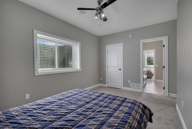 bedroom with baseboards, visible vents, ceiling fan, and carpet