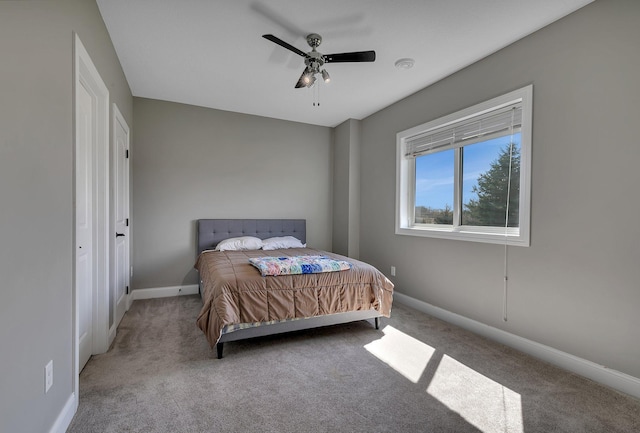 bedroom with baseboards, ceiling fan, and carpet flooring