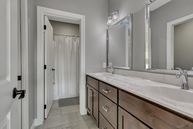 full bath with double vanity, a sink, and shower / bath combo