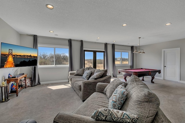 carpeted living area with recessed lighting, baseboards, and plenty of natural light