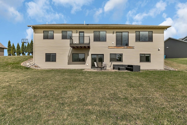 back of property featuring a yard, central AC unit, a balcony, and a patio area
