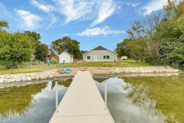 dock area featuring a lawn and a water view